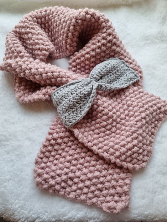 Crocheted pink scarf with grey bow