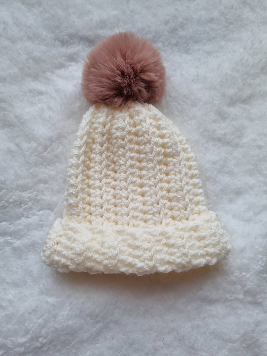 Cream, with pink pompom hat.