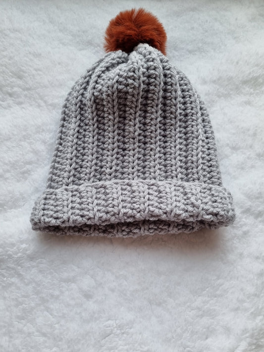 Grey hat with burnt orange faux pompom