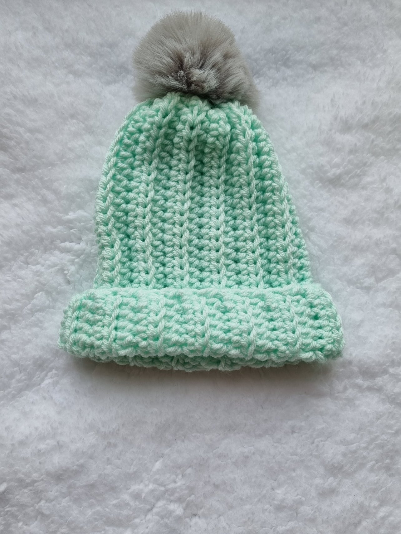 Mint hat with grey faux pompom