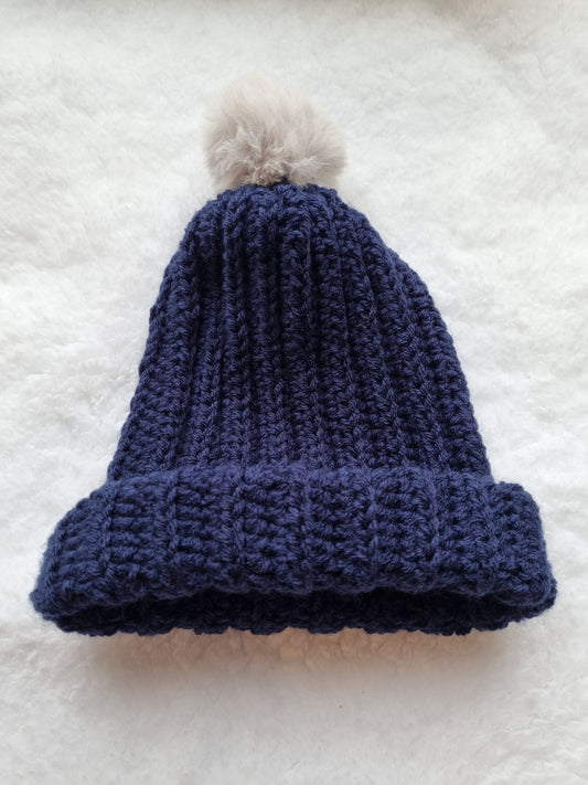 Navy hat with cream faux pompom