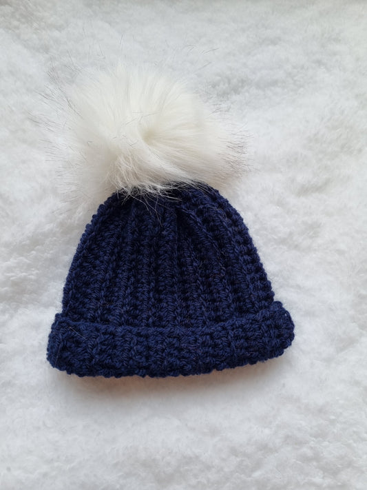 Navy hat with white faux pompom