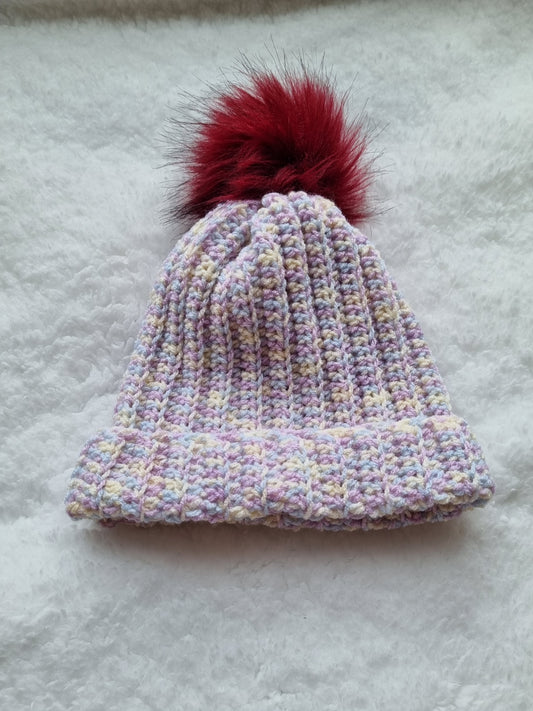 Pink flecked hat with red faux pompom