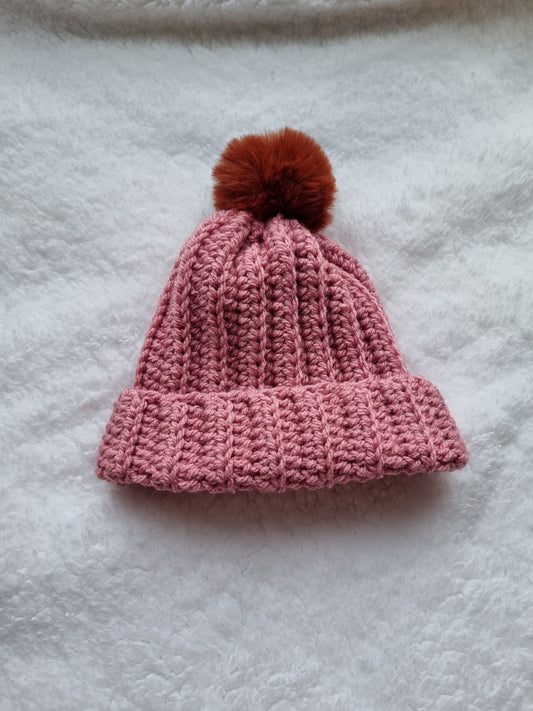 Pink hat with brown faux pompom