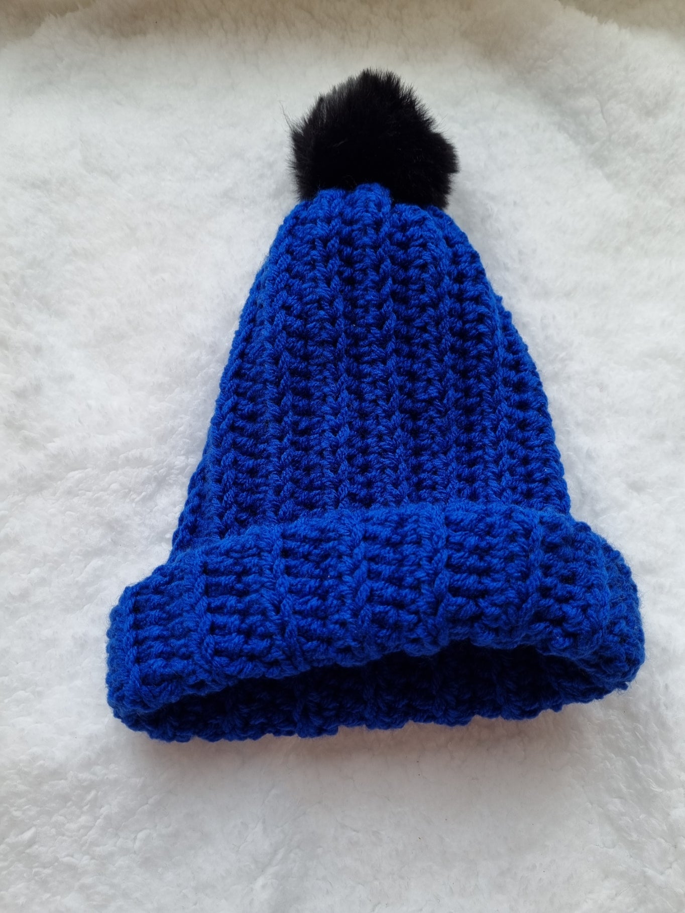 Navy hat with black pompom