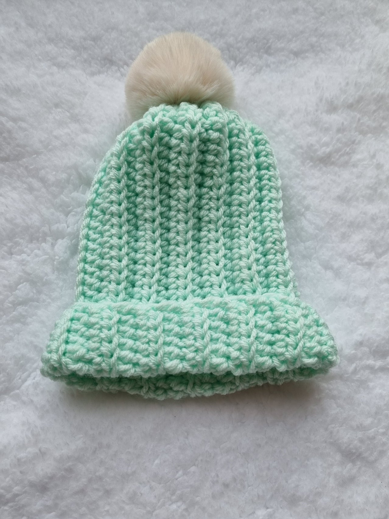 Mint hat with cream faux pompom